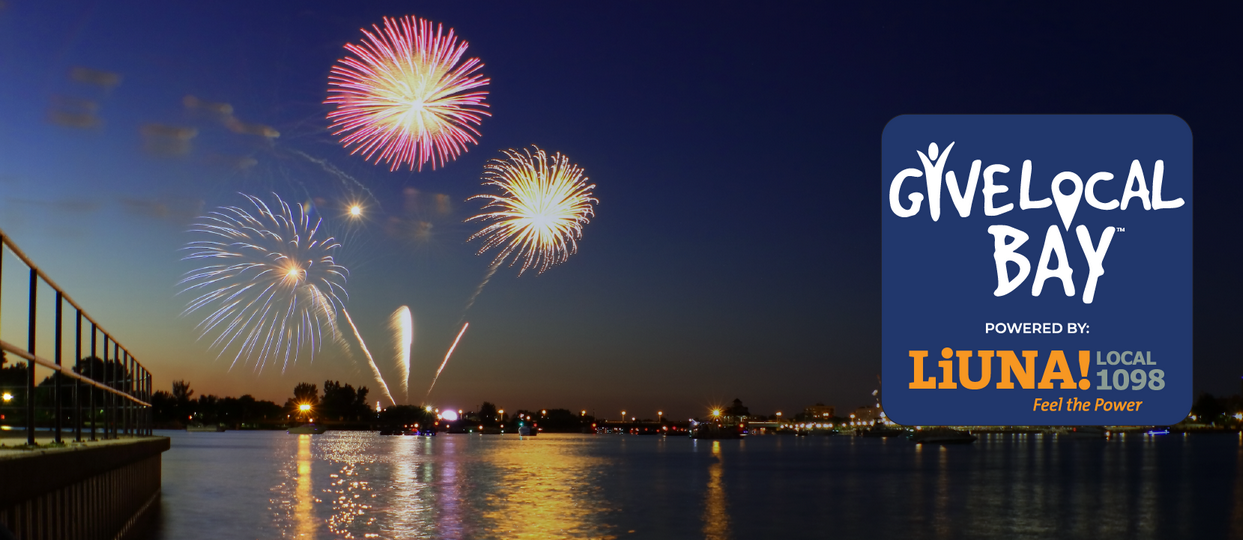 The Give Local Bay logo on a banner picture of the Bay City, Michigan river with fireworks in the background.